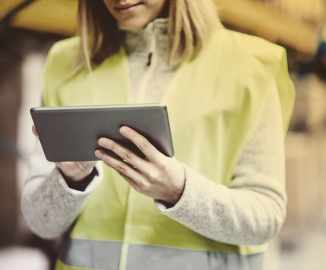 Lady in high-vis holding an iPad