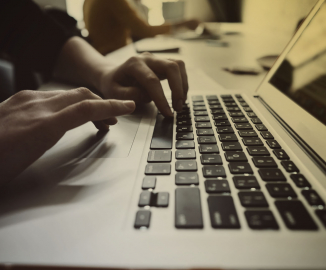 GSAS businessman typing on a laptop screen