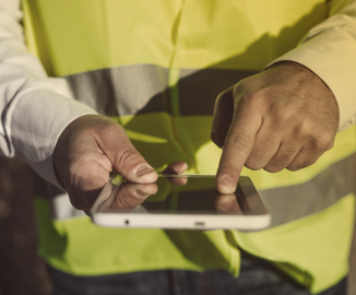 GSAS security manager on building site with ipad